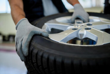 closeup-mechanic-working-with-car-tire-auto-repair-shop
